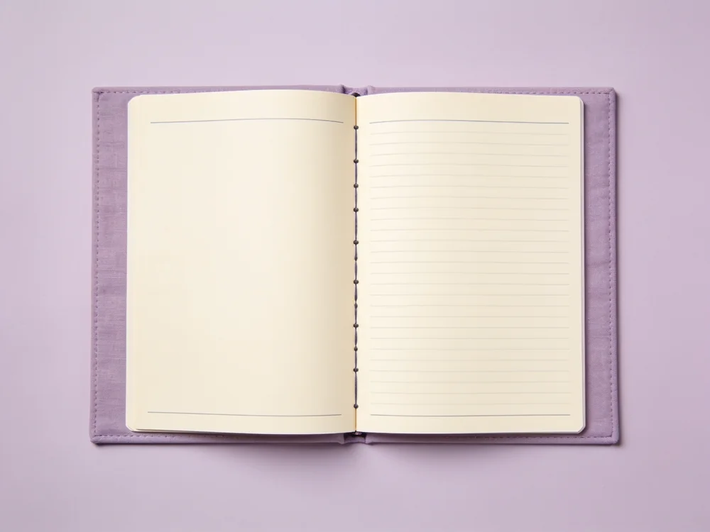 Lay-flat daily planner — Paper pages; cloth-covered sewn binding