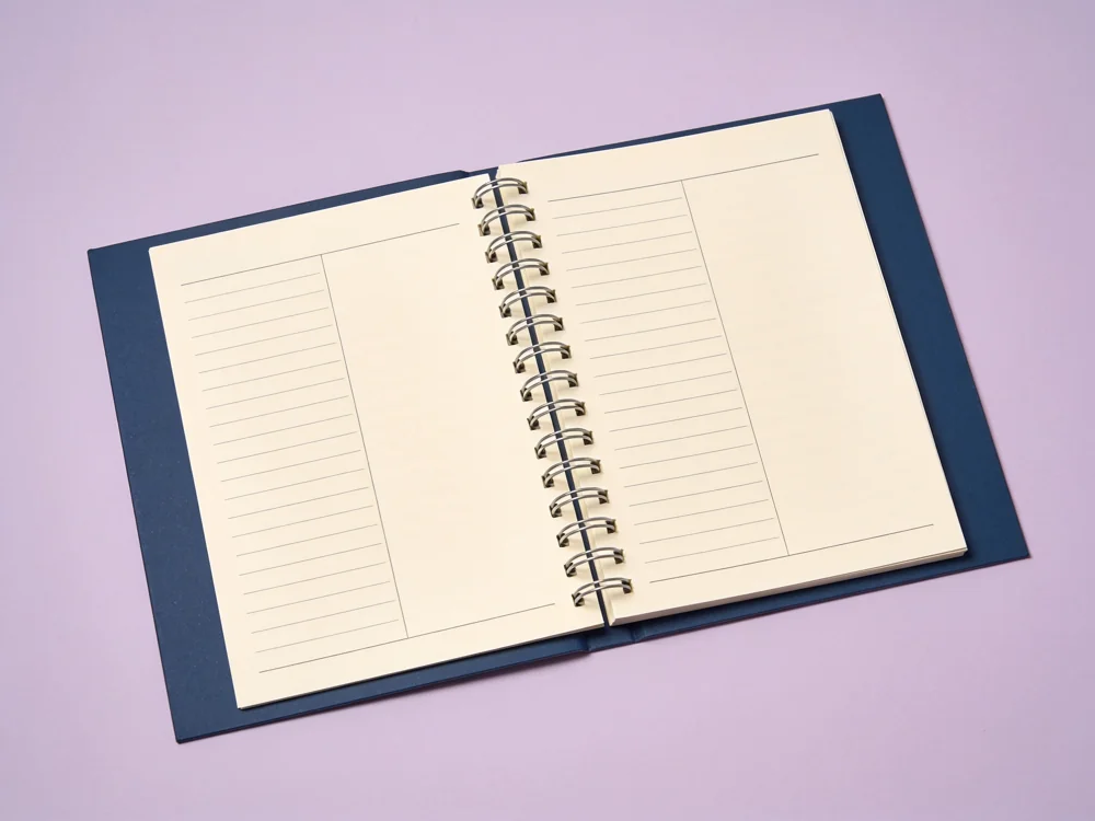 Spiral time-block planner — Paper pages; metal wire spiral binding; board cover